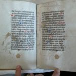 Text opening with candle wax dripped on the page ,
